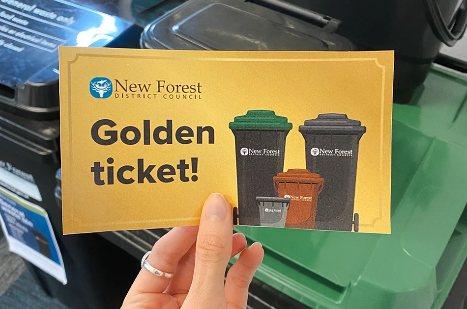 Golden ticket and 'Get Set' leaflet inside grey indoor food waste caddy